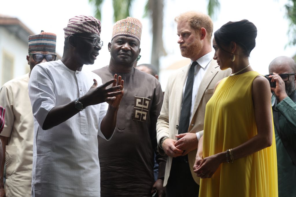 Lagos State Governor, Babajide Sanwo-Olu (L), and Nigeria Chief of Defense Staff Christopher Musa (2ndL), welcome Britain's Prince Harry (2ndR), Duke of Sussex, and  Britain's Meghan (R), Duchess of Sussex