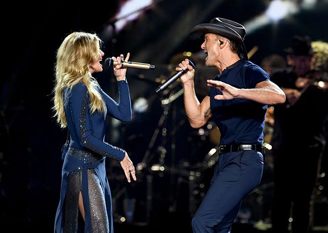 Tim McGraw and Faith Hill facing each other and singing