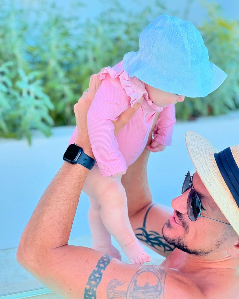 Peter andre holding baby Arabella up