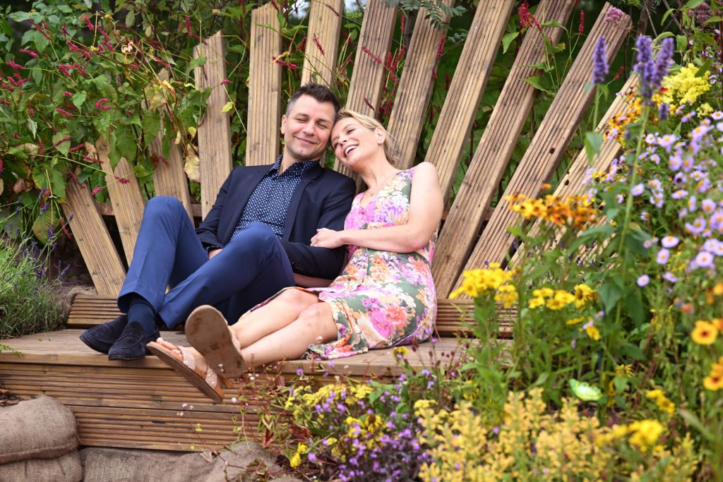 Rachel Riley and Pasha Kovalev cuddled on a bench at the Southport Flower Show