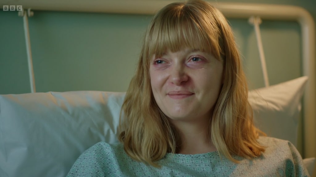 Close up of blonde woman smiling in hospital bed