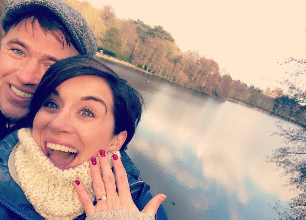 Vicky McClure showing off her engagement ring in front of a lake