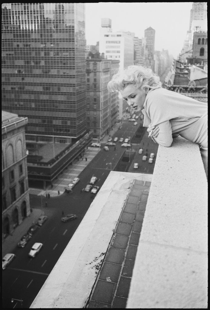 American actress Marilyn Monroe (1926 - 1962) leans over the balcony of the Ambassador Hotel in March 1955 in New York City