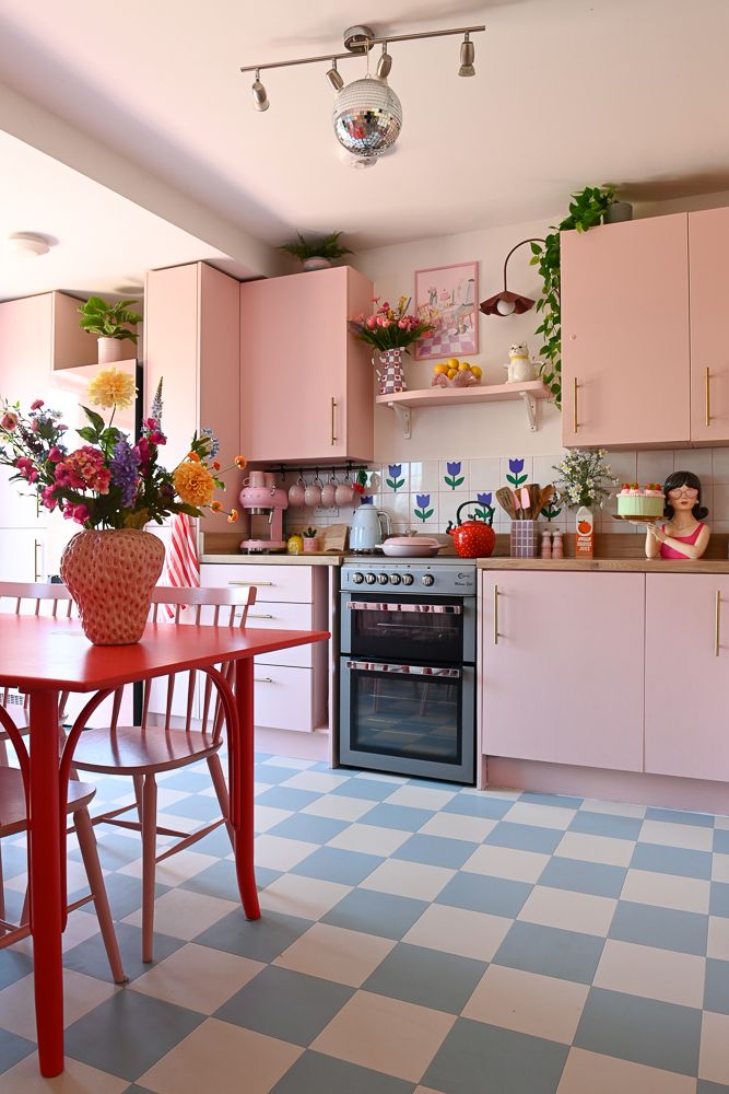 kitchen with checkerboard floor and pink cabinets