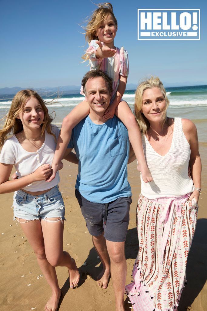 Tabitha Webb posing on beach in South Africa with husband Gavin Ferrar and children Betsey and Primrose 
