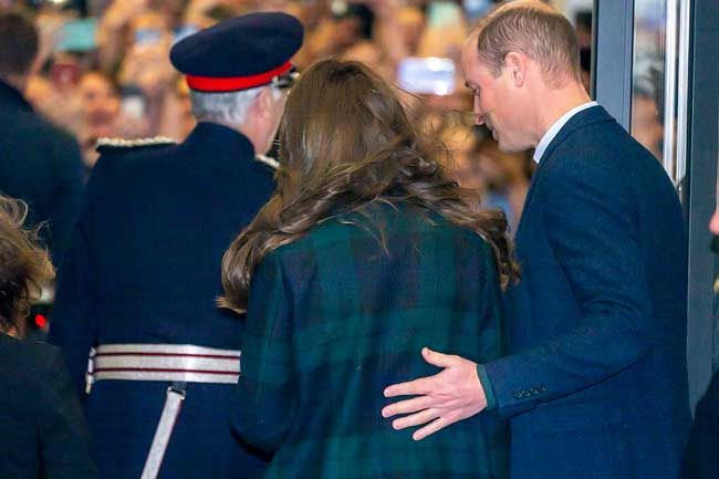 Prince William puts his hand on wife Kates back