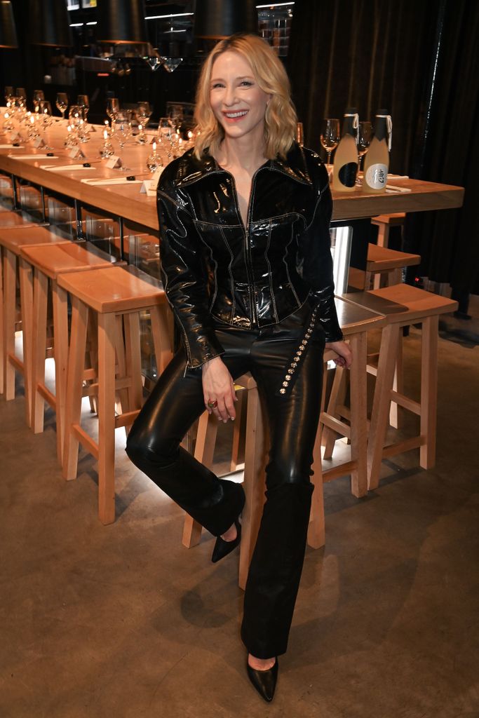 Cate Blanchett sitting in restaurant in leather 