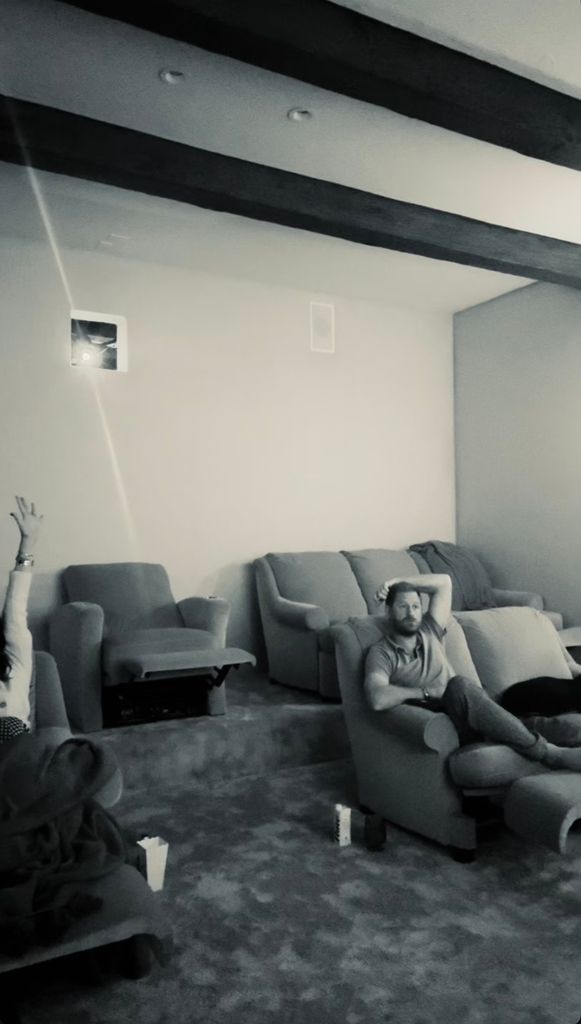 black and white photo of prince harry in home cinema
