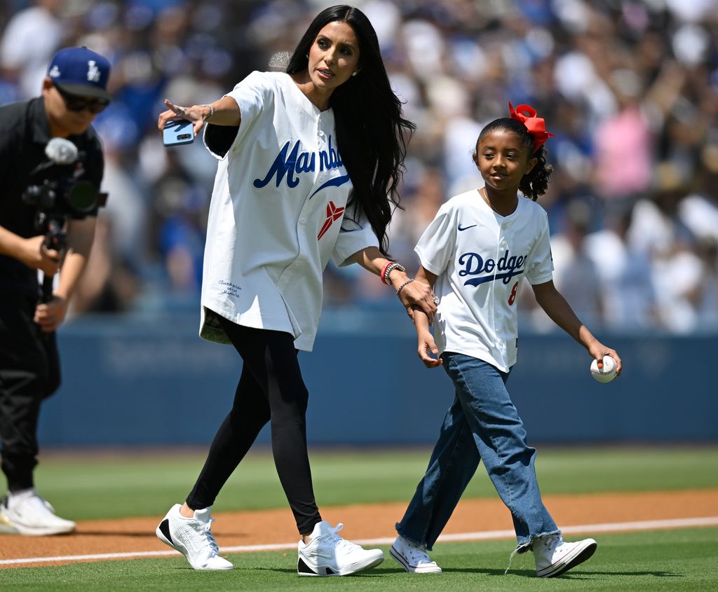 Vanessa Bryant walks her daughter Bianca Bryant, the daughter of former Los Angeles Laker Kobe Bryant, walk out to throw the first pitch before a MLB baseball game 