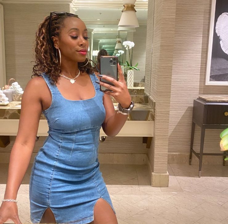 Scarlette Douglas taking a selfie in a bathroom while wearing a denim outfit