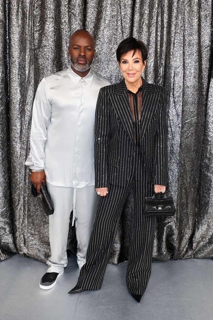 Corey Gamble in white and Kris Jenner in a black suit
