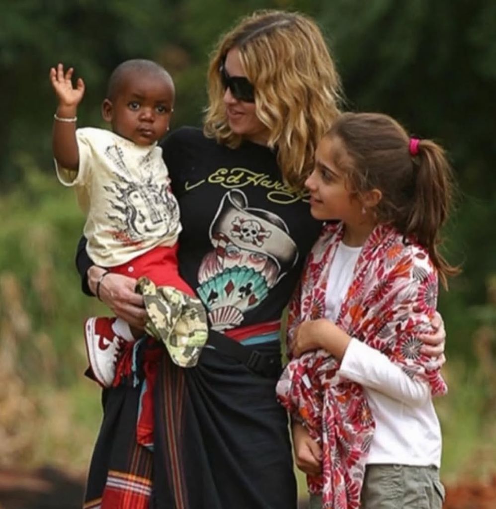 David Banda swiling and being held by madonna