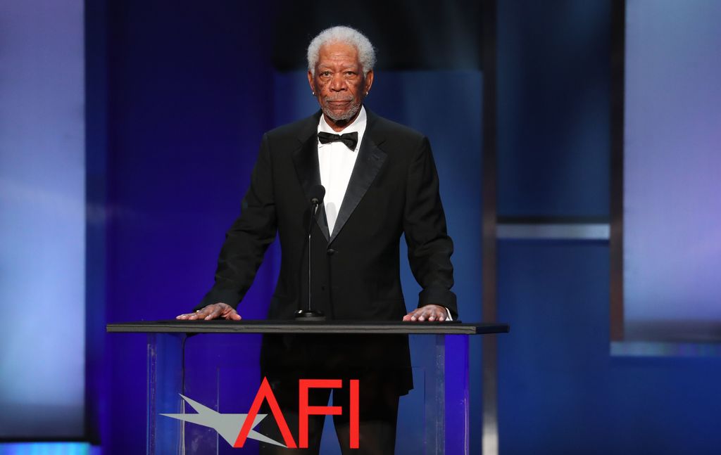 Morgan Freeman standing at a plinth