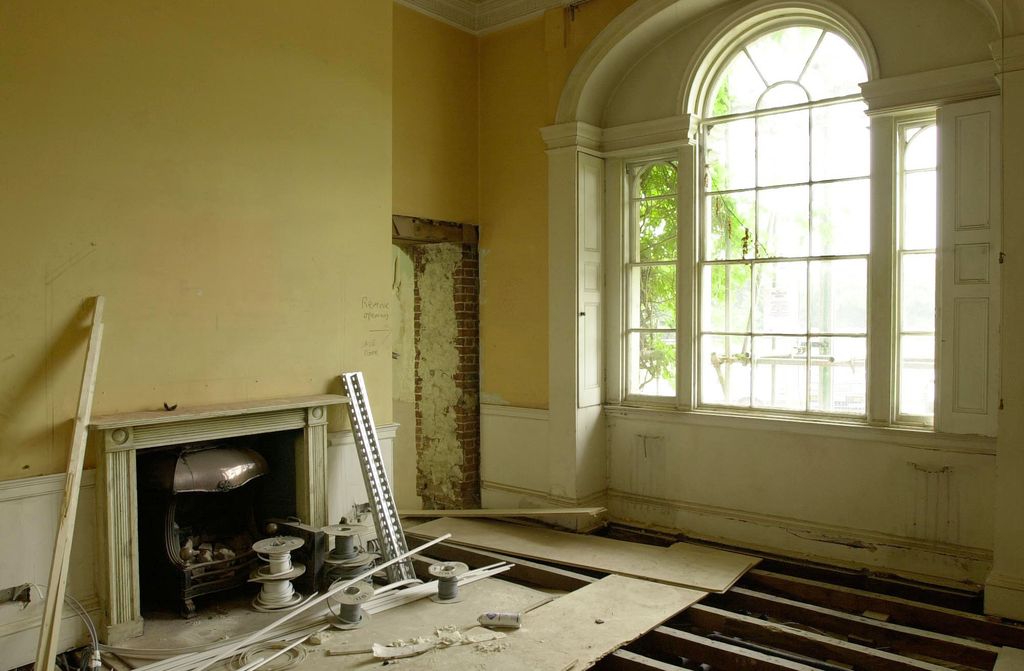 Forest Lodge room with marble fireplace and floorboards missing