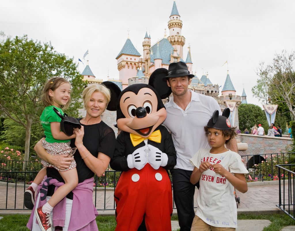 In this handout photo provided by Disneyland, Actor Hugh Jackman, his wife Deborra Lee Furness, and children Oscar Jackman and Ava Jackman pose with Mickey Mouse outside Sleeping Beauty Castle at Disneyland on April 23, in Anaheim, Calif.