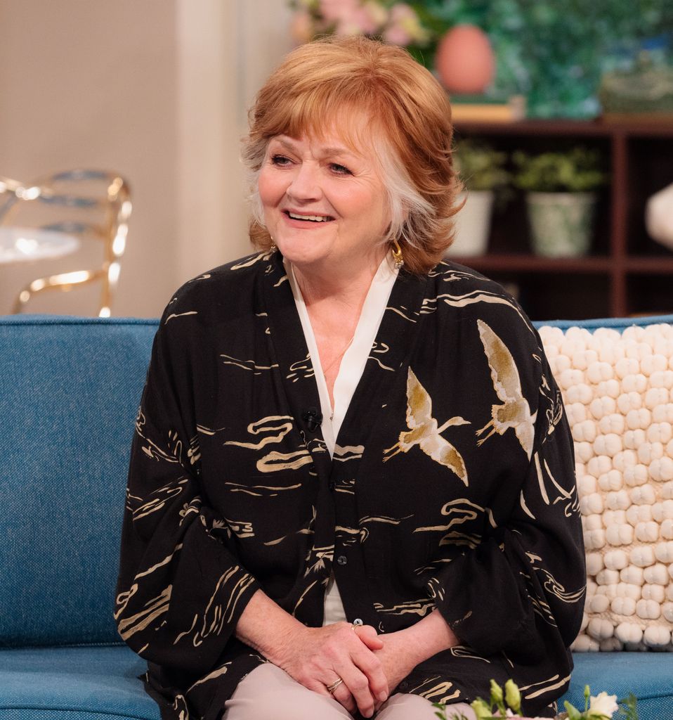 woman sitting on clue sofa in tv studio