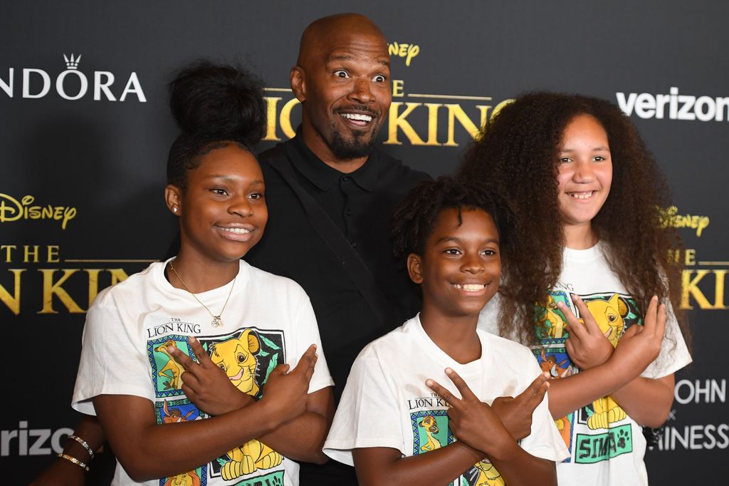 TOPSHOT - US actor Jamie Foxx (C), daughter Anelise (R) and friends arrive for the world premiere of Disney's "The Lion King" at the Dolby theatre on July 9, 2019 in Hollywood. (Photo by Robyn Beck / AFP) (Photo by ROBYN BECK/AFP via Getty Images)