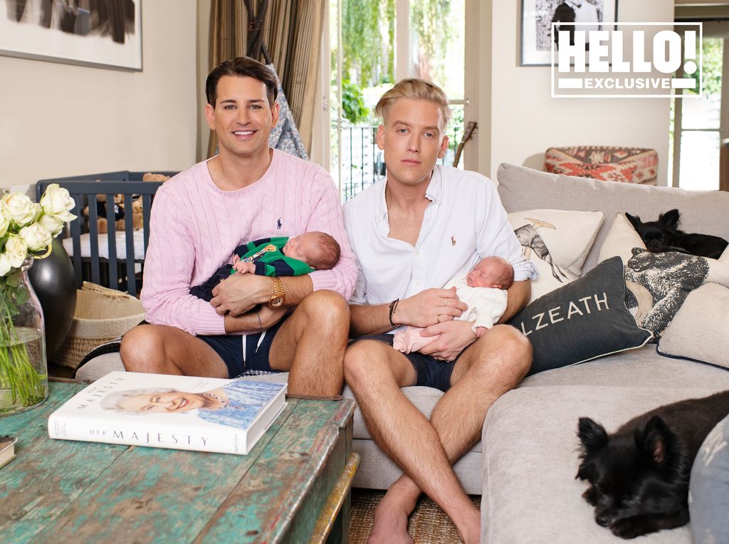 Ollie Locke and Gareth hold their babies while sat on the sofa