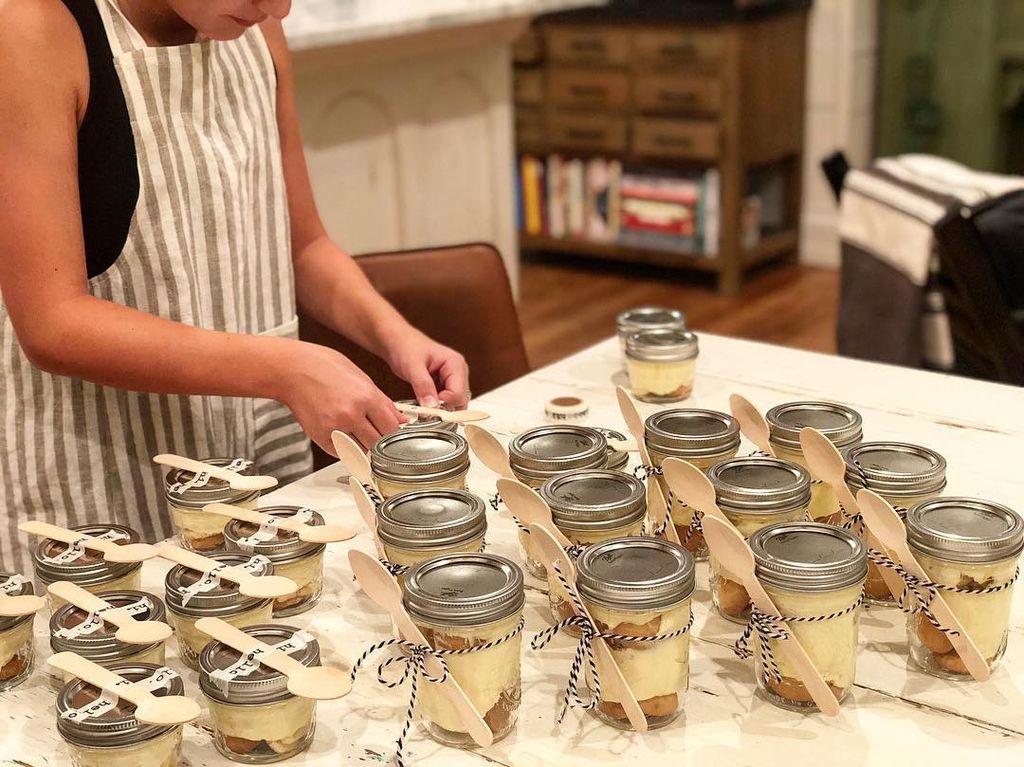 Ella Gaines prepares several mason jars of baked goods for Magnolia employees, shared by Joanna Gaines on Instagram