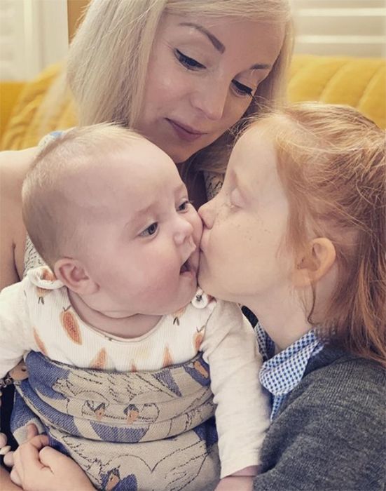 Helen Georges daughters share a kiss