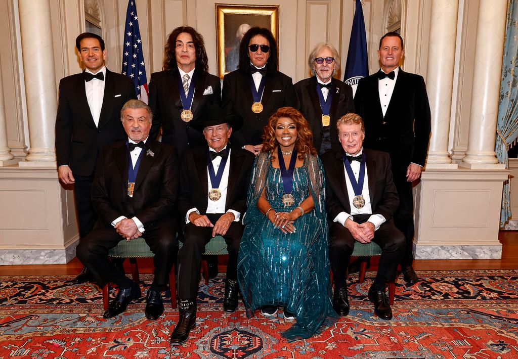 Secretary of State Marco Rubio, Paul Stanley, Gene Simmons, Peter Criss, Amb. Richard Grenell and (Front Row L-R) Sylvester Stallone, George Strait, Gloria Gaynor, Michael Crawford 