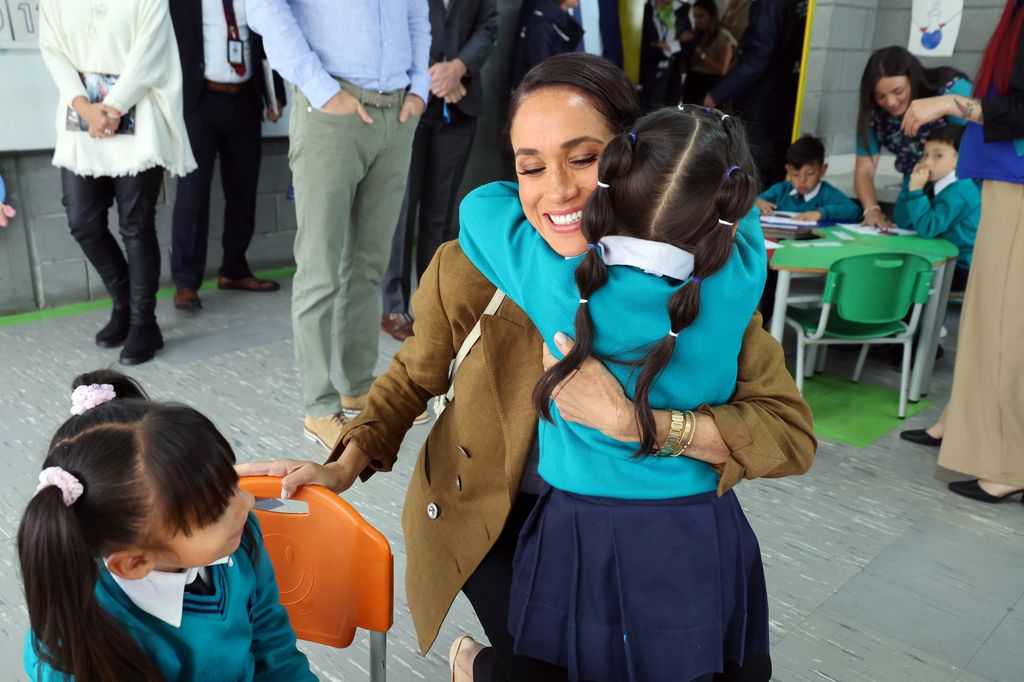 Meghan hugging school girls