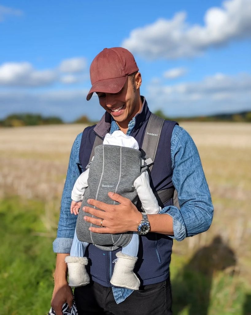 Repair Shop star Will Kirk holding baby in sling 