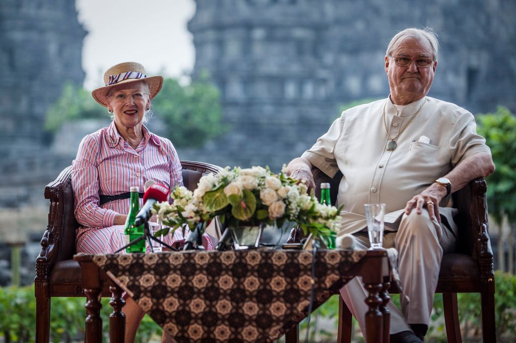 Queen Margrethe II of Denmark and her husband, Prince Henrik talk to journalist during their visit at Prambanan temple