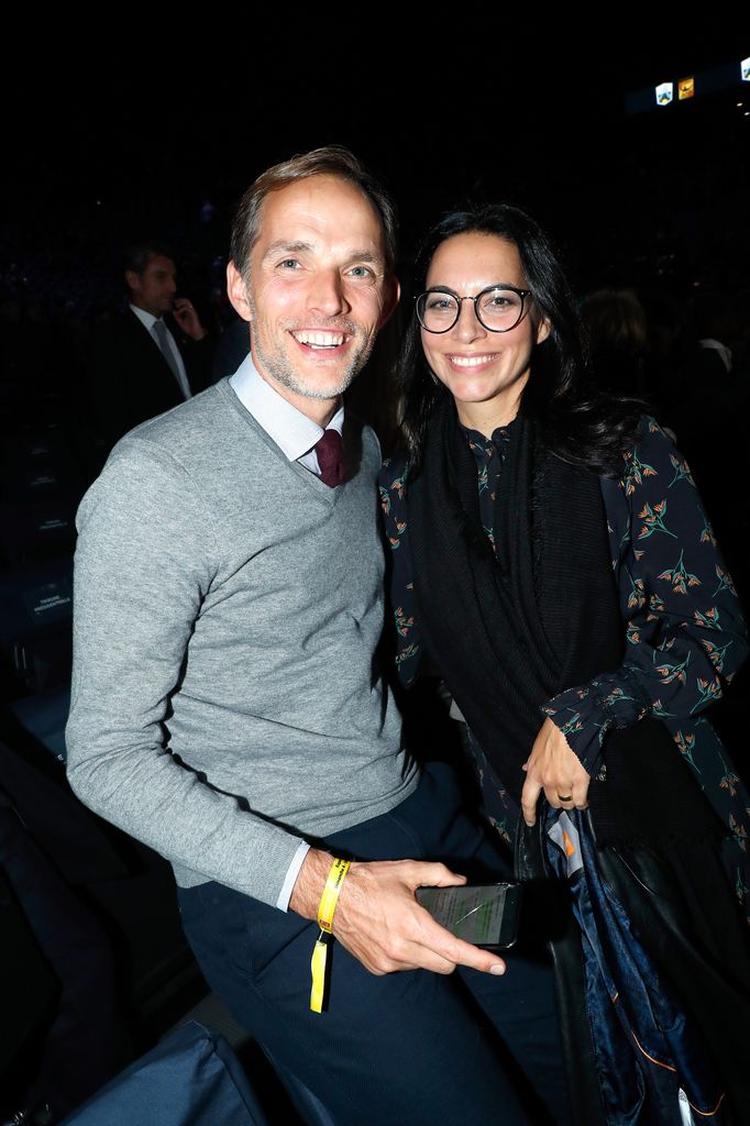 Thomas Tuchel in a grey jumper and blue trousers with Sissi Tuchel in a patterned dress