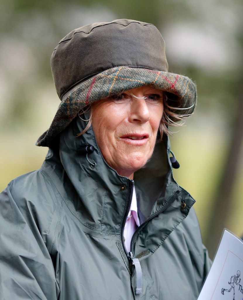 queen camilla in a rain hat and rain coat
