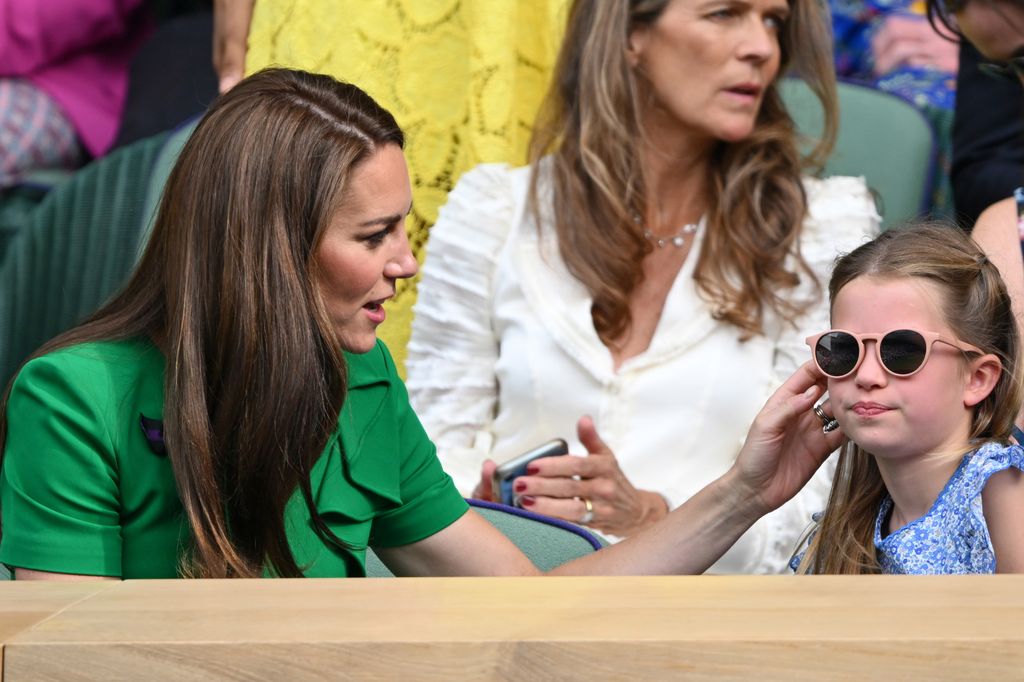Kate touching Charlotte's hair sat in royal box
