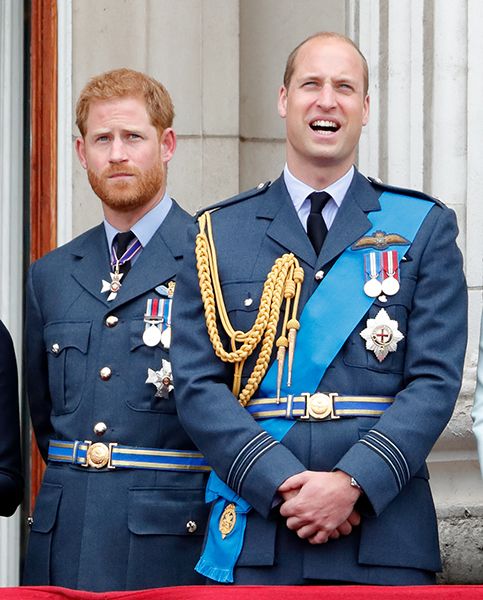 A sad looking Prince Harry stood next to a cheering Prince William
