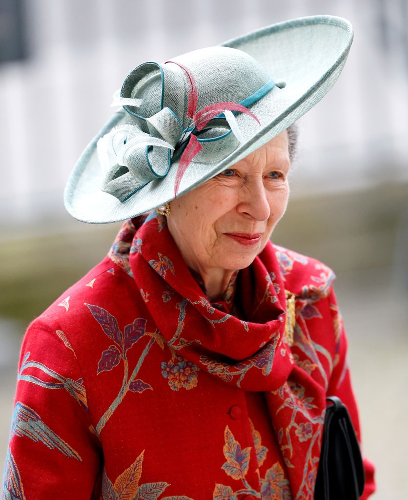 Princess Anne in red printed coat and blue hat