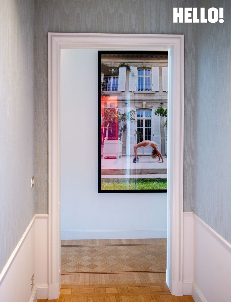Contemporary art hanging on one of the walls in the hallway in the hree-storey apartment in Antwerp’s Graanmarkt Square