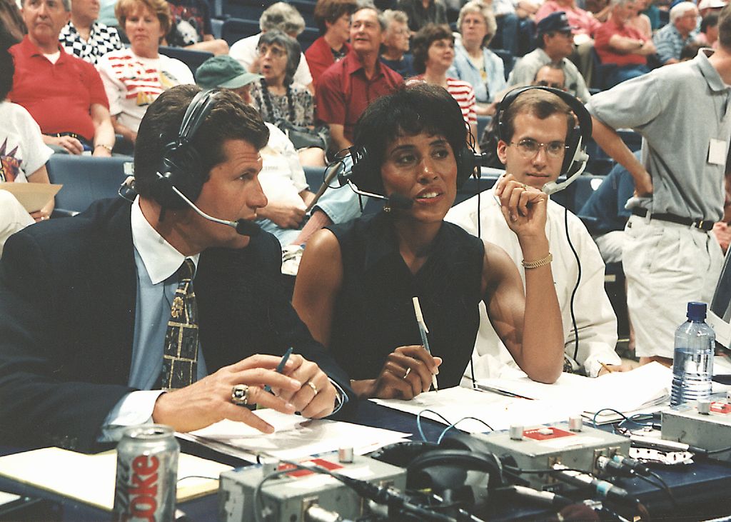 ESPN network commentator Robin Roberts (right) and Italian-born American basketball coach Geno Auriemma of the University of Connecticut broadcast an exhibition game between Connecticut and the New York Liberty, Storrs, Connecticut, 1998