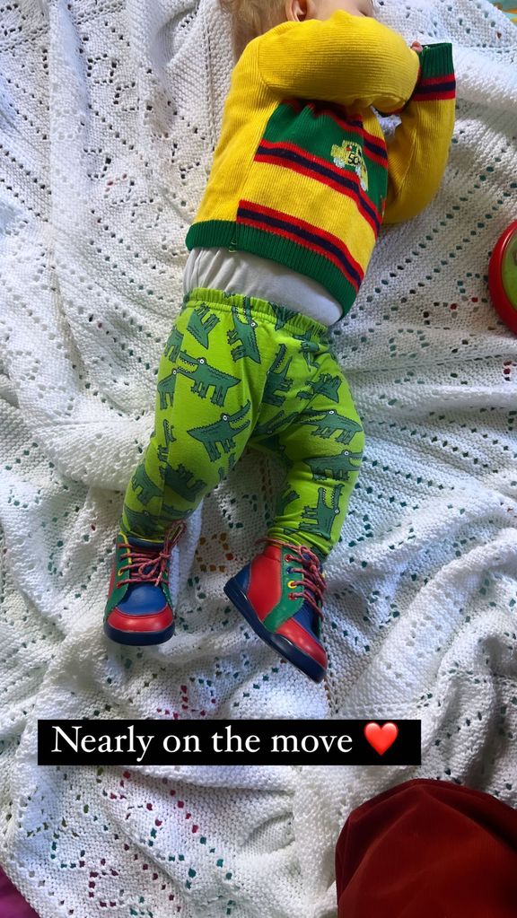 A photo of baby Frankie wearing brightly coloured shoes