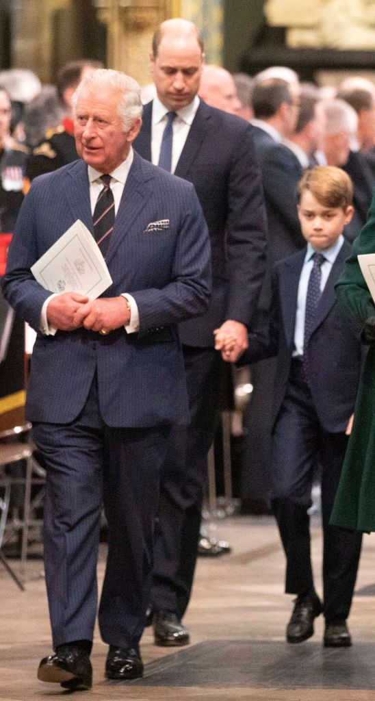 King Charles walking with Prince William and Prince George behind him