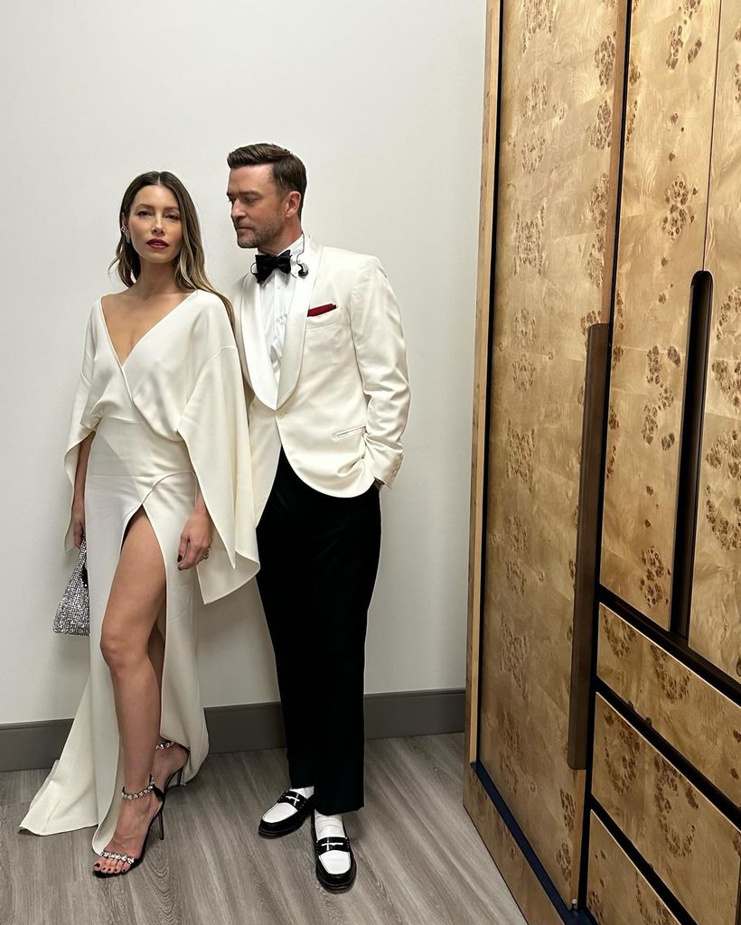 Jessica Biel in white satin thigh split dress with white tux clad husband Justin Timberlake