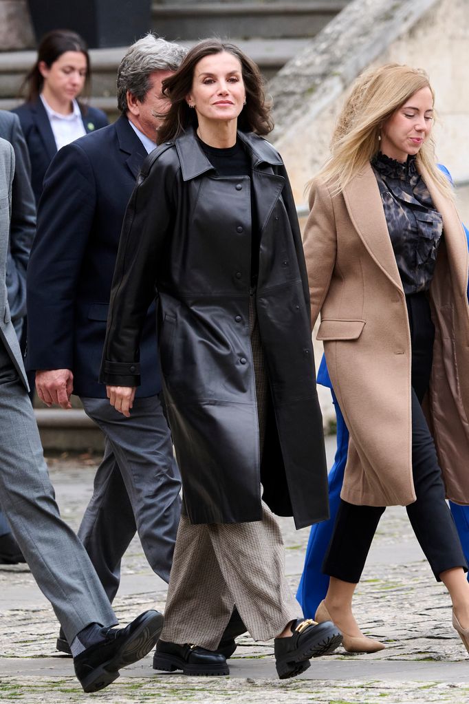 Queen Letizia Letizia in check trousers and black top and leather jacket
