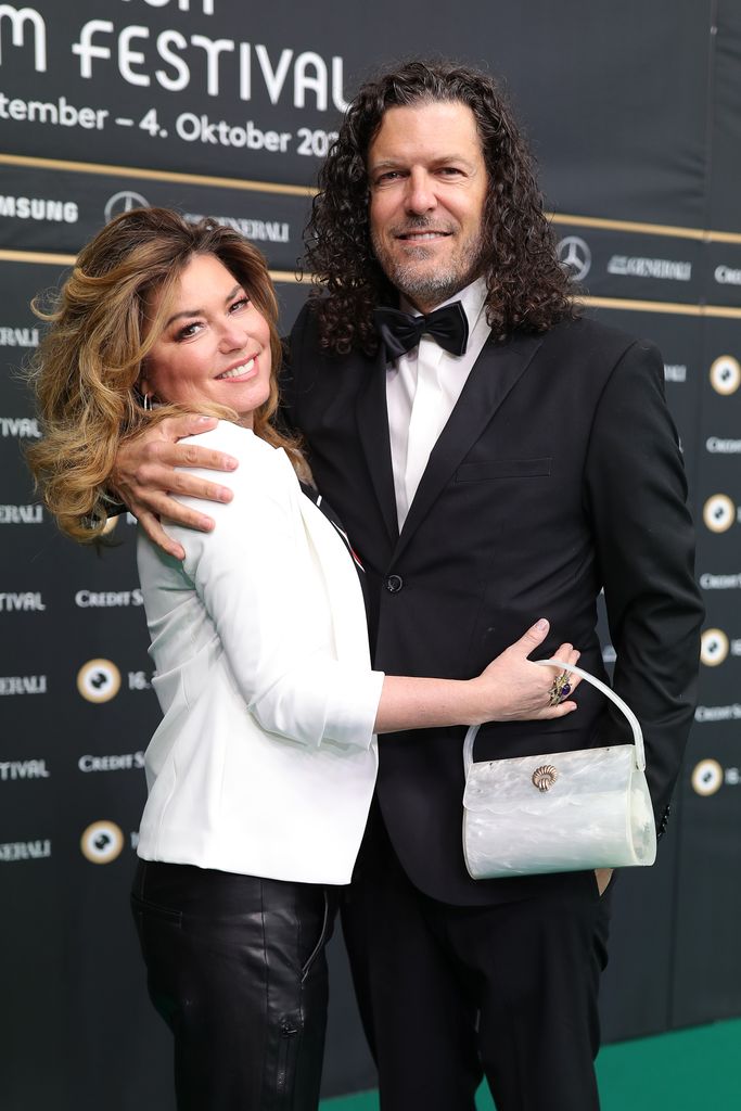 Frederic Thiebaud with his arm around Shania Twain's back
