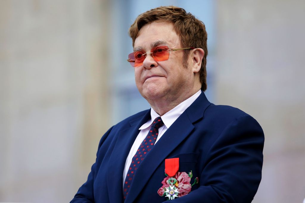 Elton John addresses a crowd in the courtyard of the Elysee Palace in Paris
