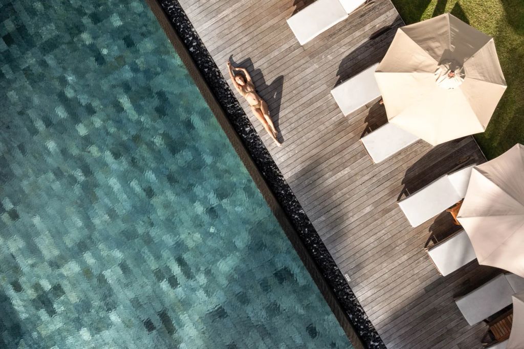 woman sunbathing by a pool at the Prince Maurice