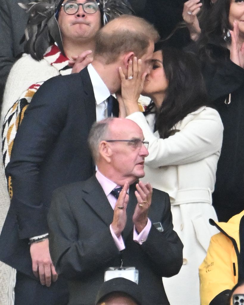 Prince Harry, Duke of Sussex and Meghan, Duchess of Sussex kiss during the opening ceremony 