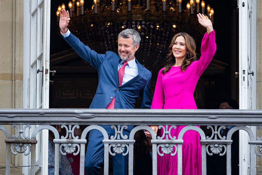 King Frederik and Queen Mary holding hands on the balcony of Amalienborg Palace