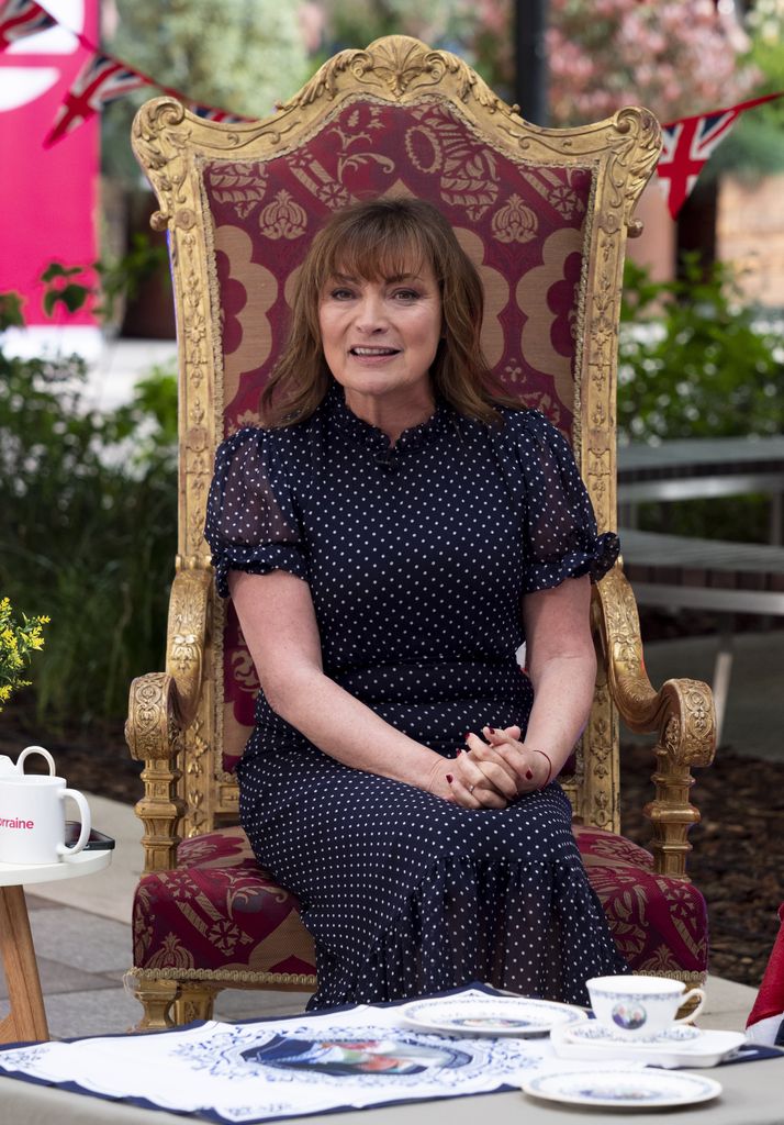 Lorraine Kelly wears flowing polka dot dress as she sits on mock throne for TV show