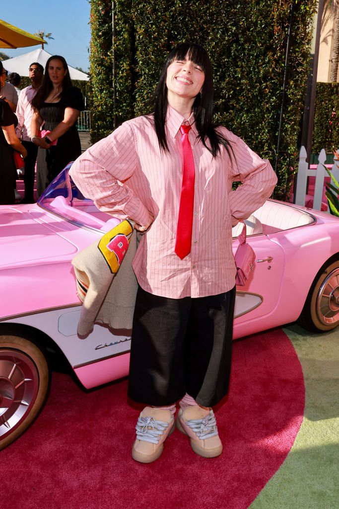 Billie Eilish in a pink shirt and black trousers at the Barbie premiere