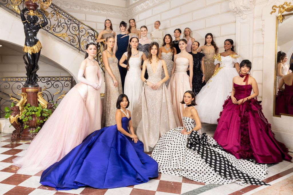 Group photo with the debutantes in gowns for Le Bal 2025 on staircase