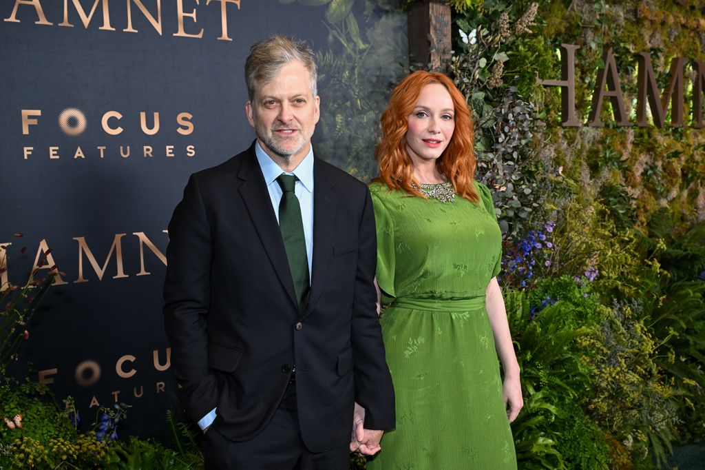 photo of christina hendricks in green dress holding hands husband george bianchini red carpet