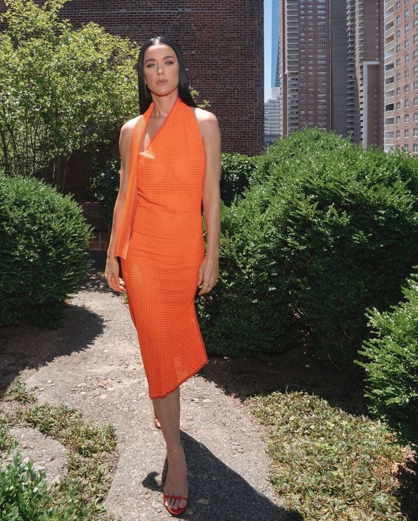 Katy Perry walks through park in NYC wearing orange dress