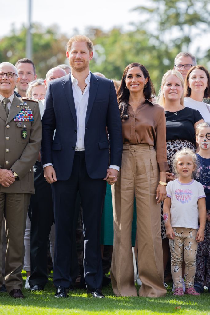 Prince Harry and Meghan Markle posing for a group shot